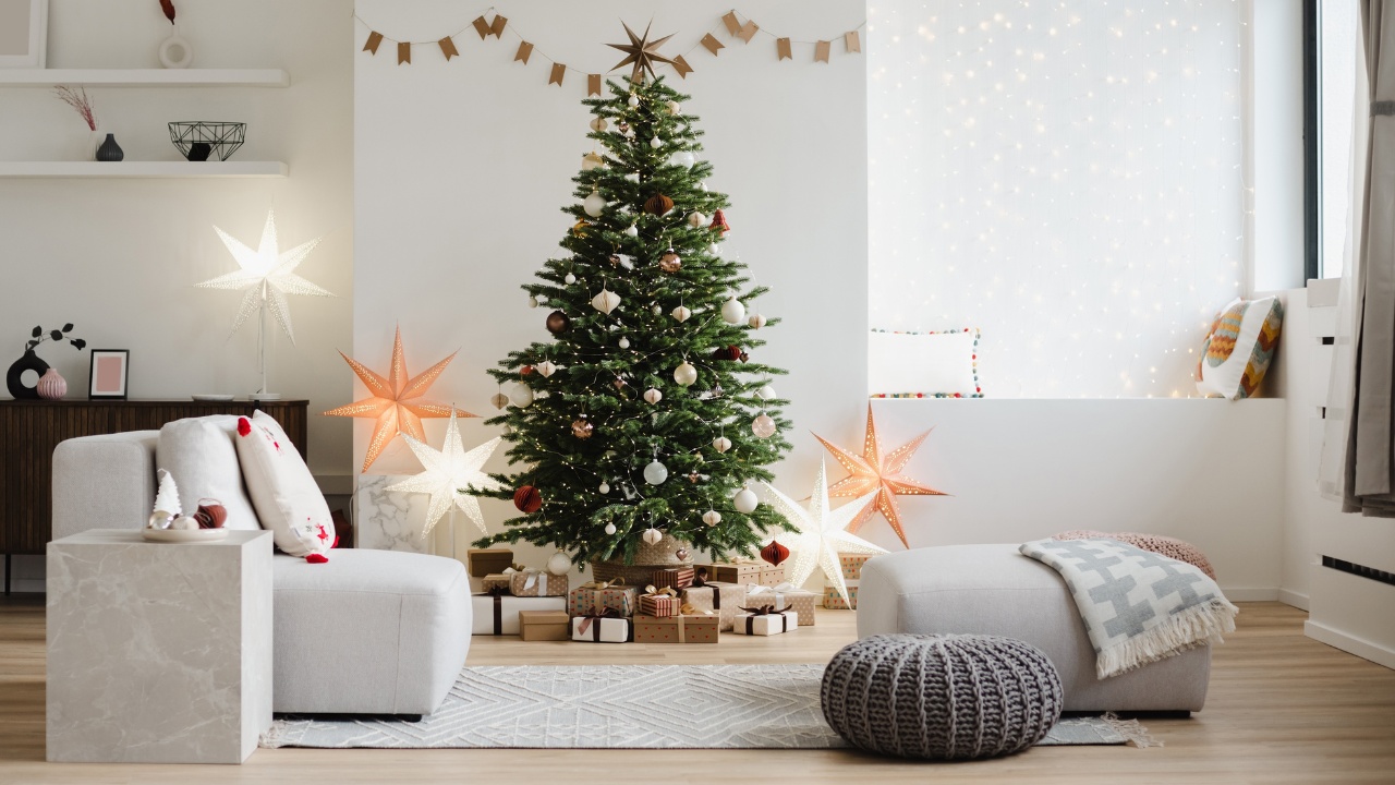Decorated Christmas tree with decorations, gifts and lights at home. 