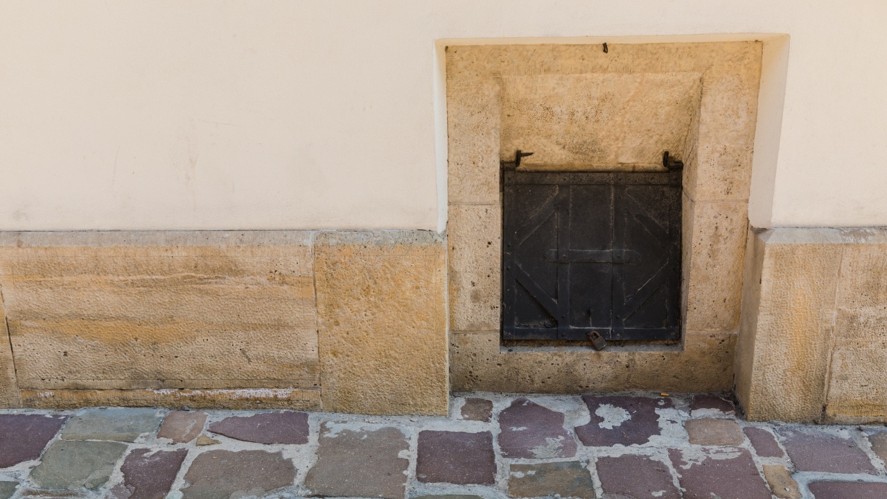 A wooden hatch in the facade of the building, chute for discharging coal into the basement.