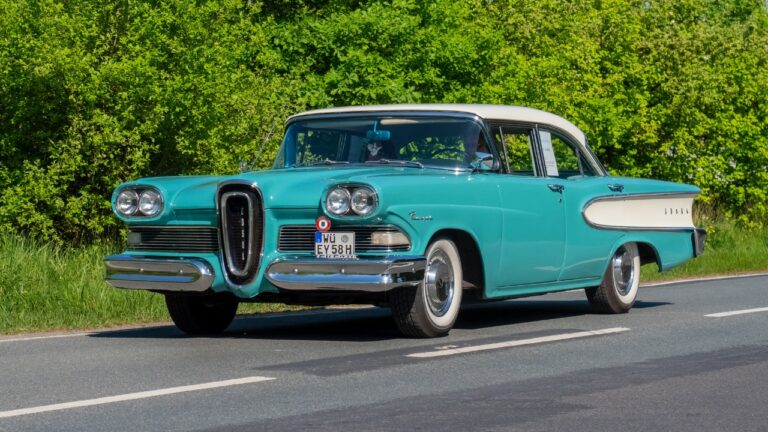 Front-side view of a turquoise Edsel Ranger Sedan driving down the roadway.
