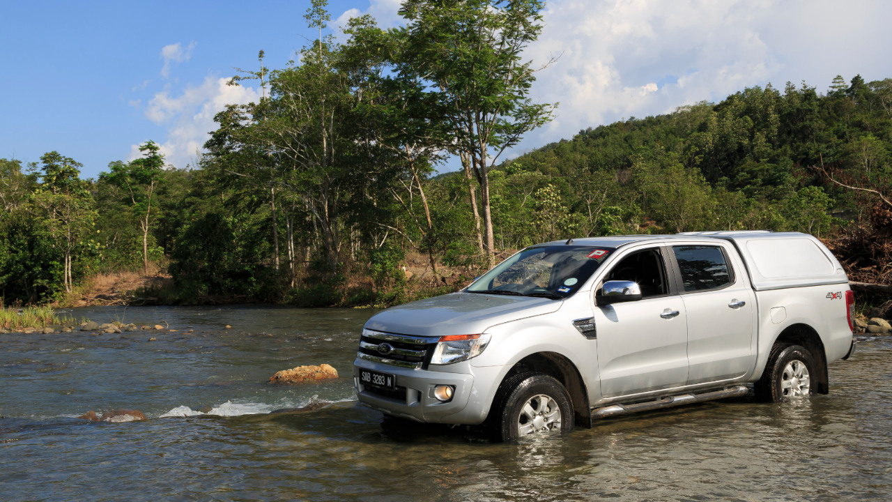 Ford Ranger truck in a river in Taman Serinsim, Sabah, Malaysia
