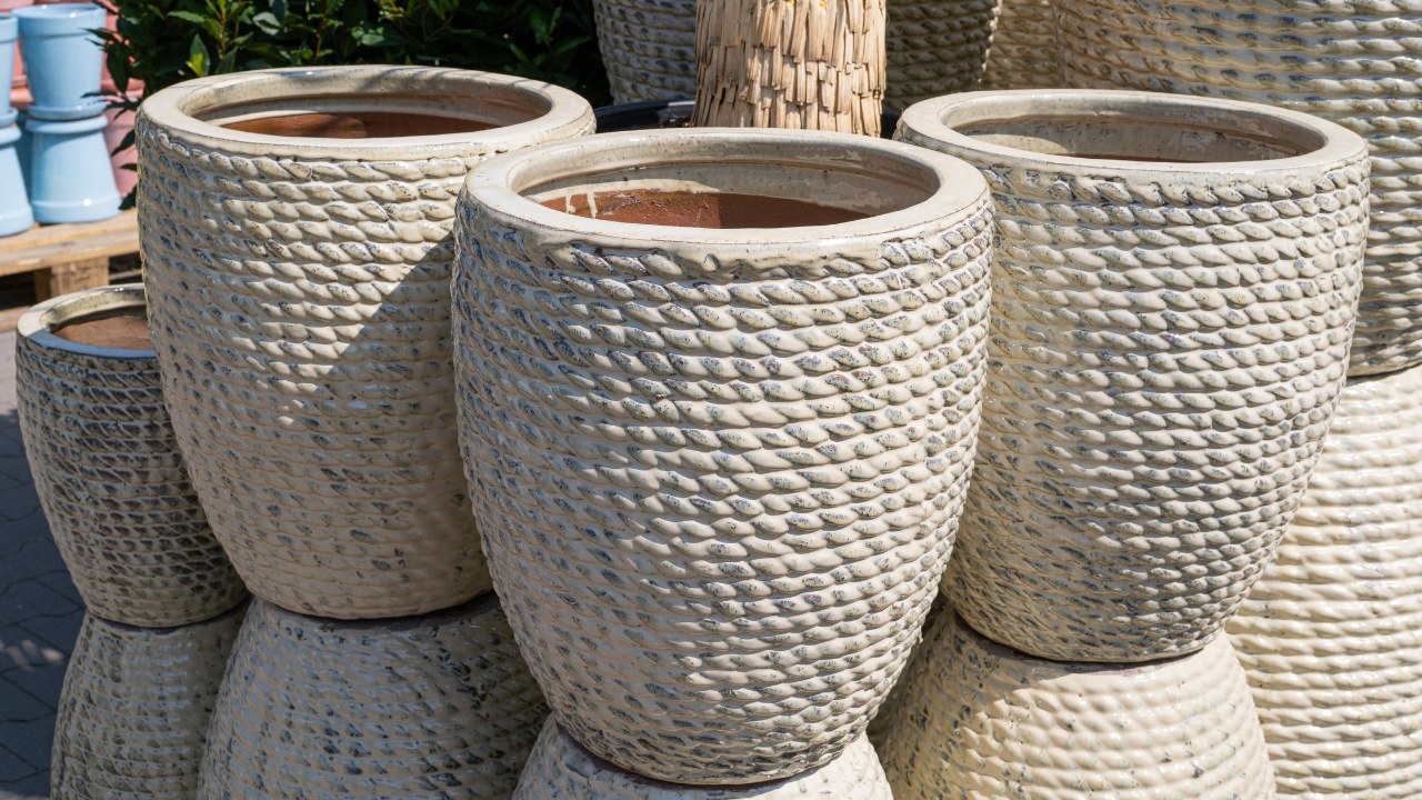 An assortment of heavy stone pots at a garden store.