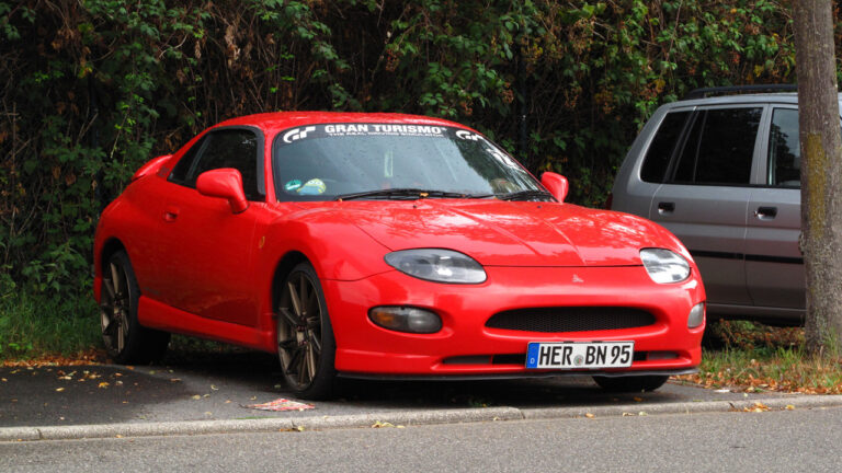 Mitsubishi FTO, front 3/4 view, red exterior, bronze aftermarket wheels