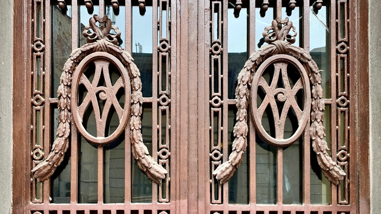 A screen door with lettering and detailing.