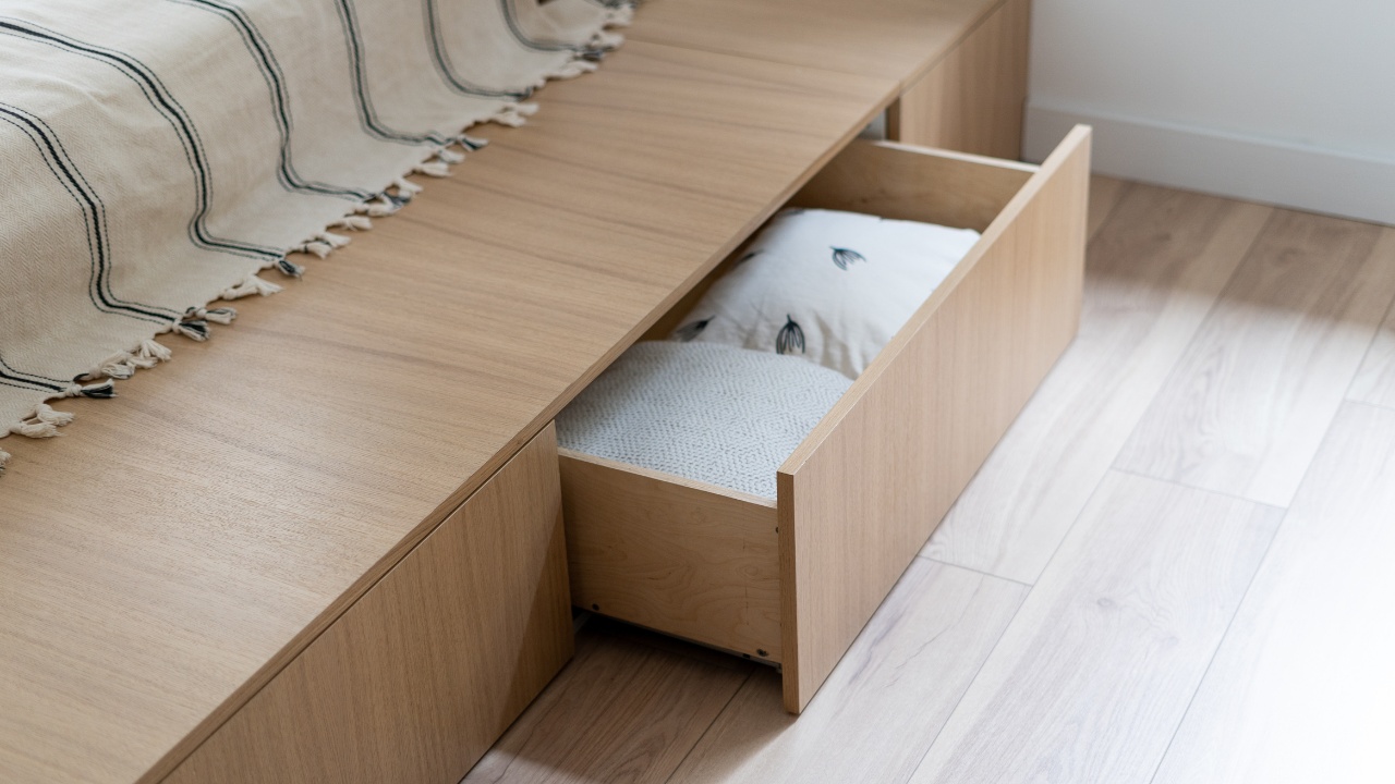 Bedroom interior, wooden bed at modern room. Furniture design with open wood drawer, white pillow decoration object in box. Brown comfortable storage for bedding cushion.