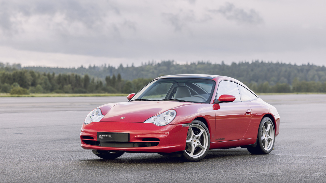 Porsche 911 996, front 3/4 view, red exterior, five spoke wheels, runway