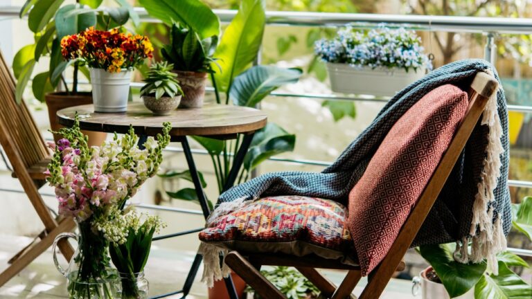 View of a cozy balcony or terrace full of green plants.