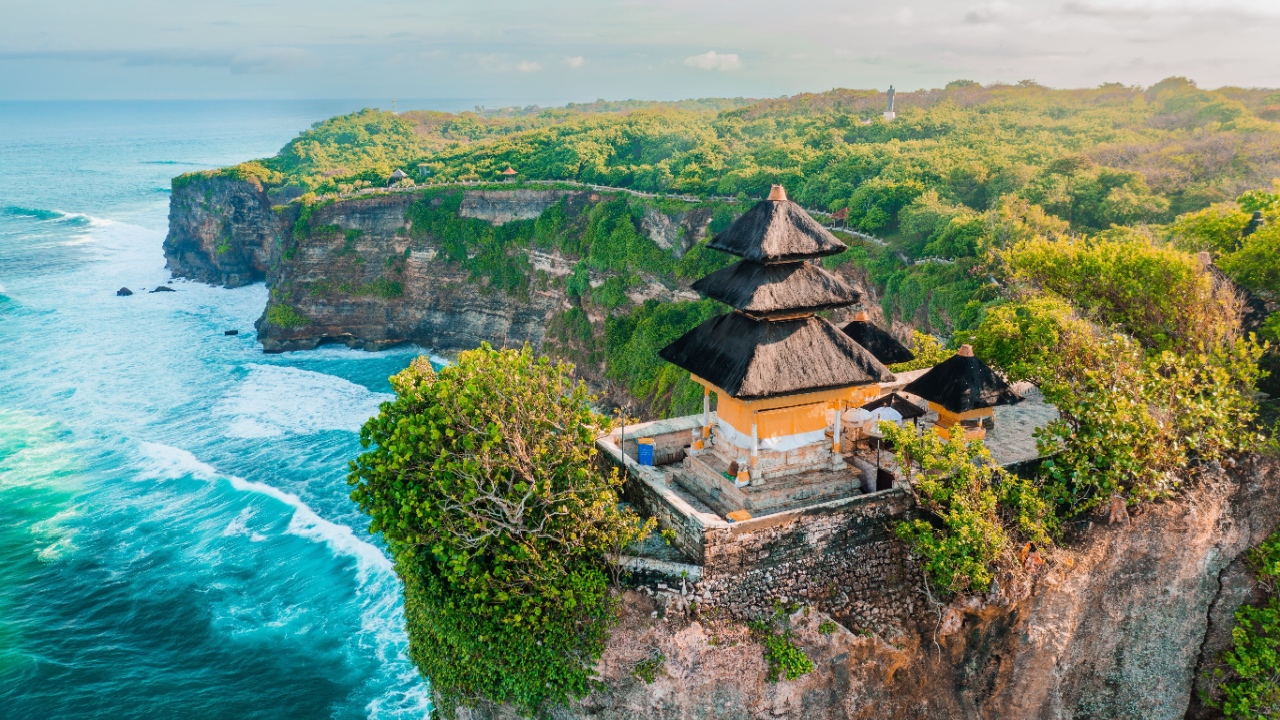 Bali's Most Iconic Landmark and popular tourist attraction Uluwatu Temple one of six key Bali temple perched on top mountain cliff.