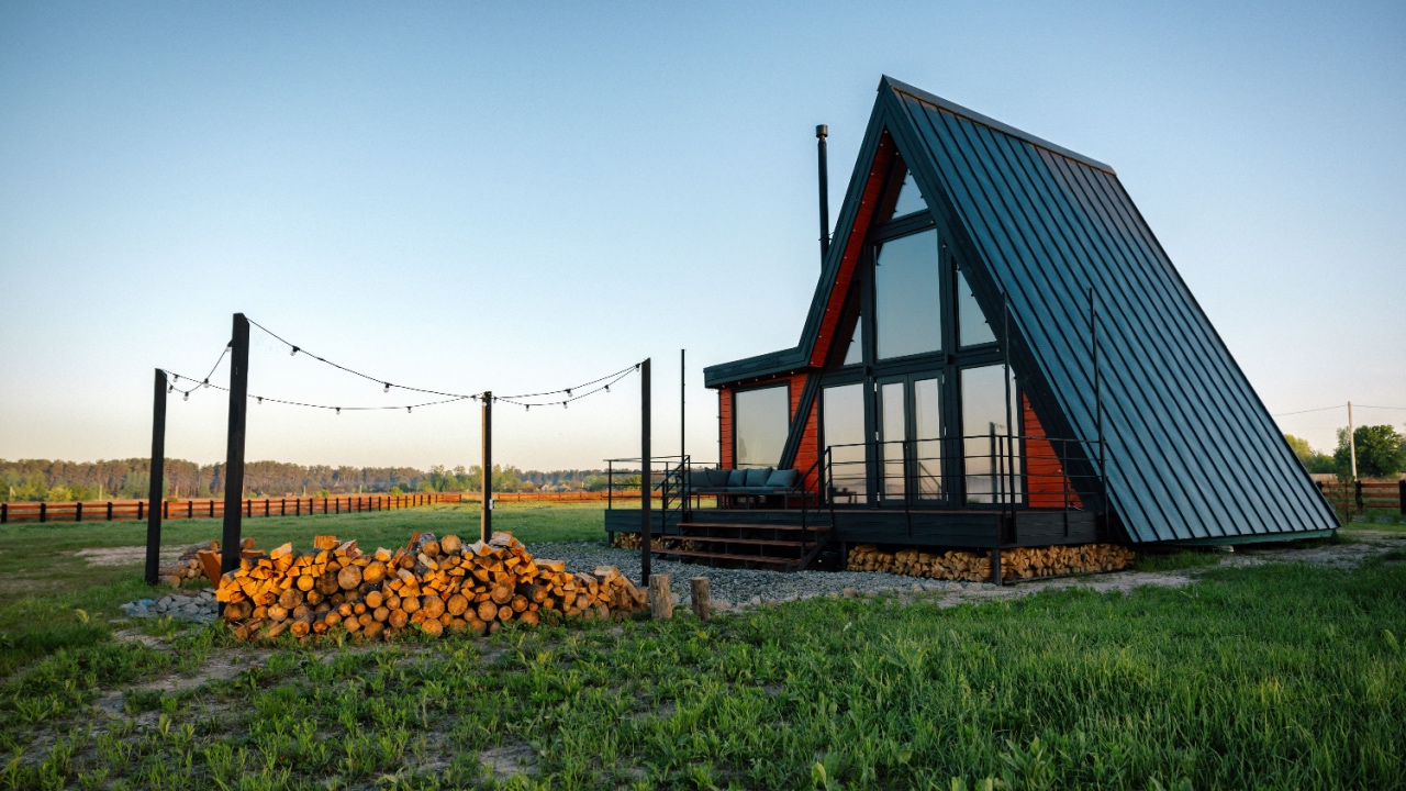 Wooden luxury A-Frame tiny house lodge with terrace and fire place