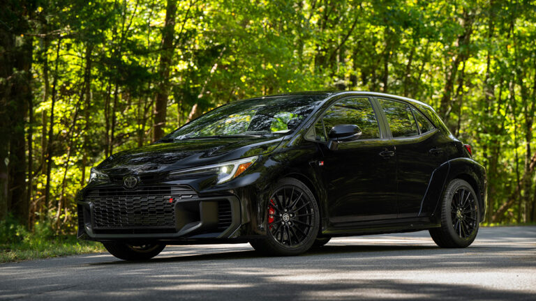 Toyota GR Corolla, black, front 3/4 view, forest area