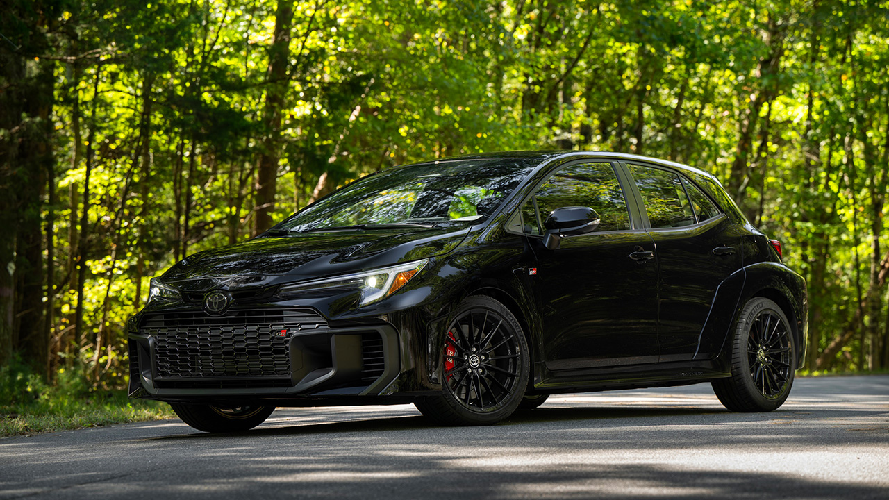 Toyota GR Corolla, black, front 3/4 view, forest area
