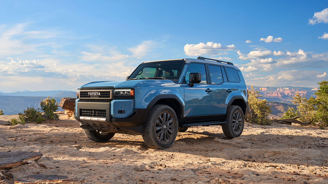Toyota Land Cruiser 250, blue, front 3/4 view, canyon, off-road.