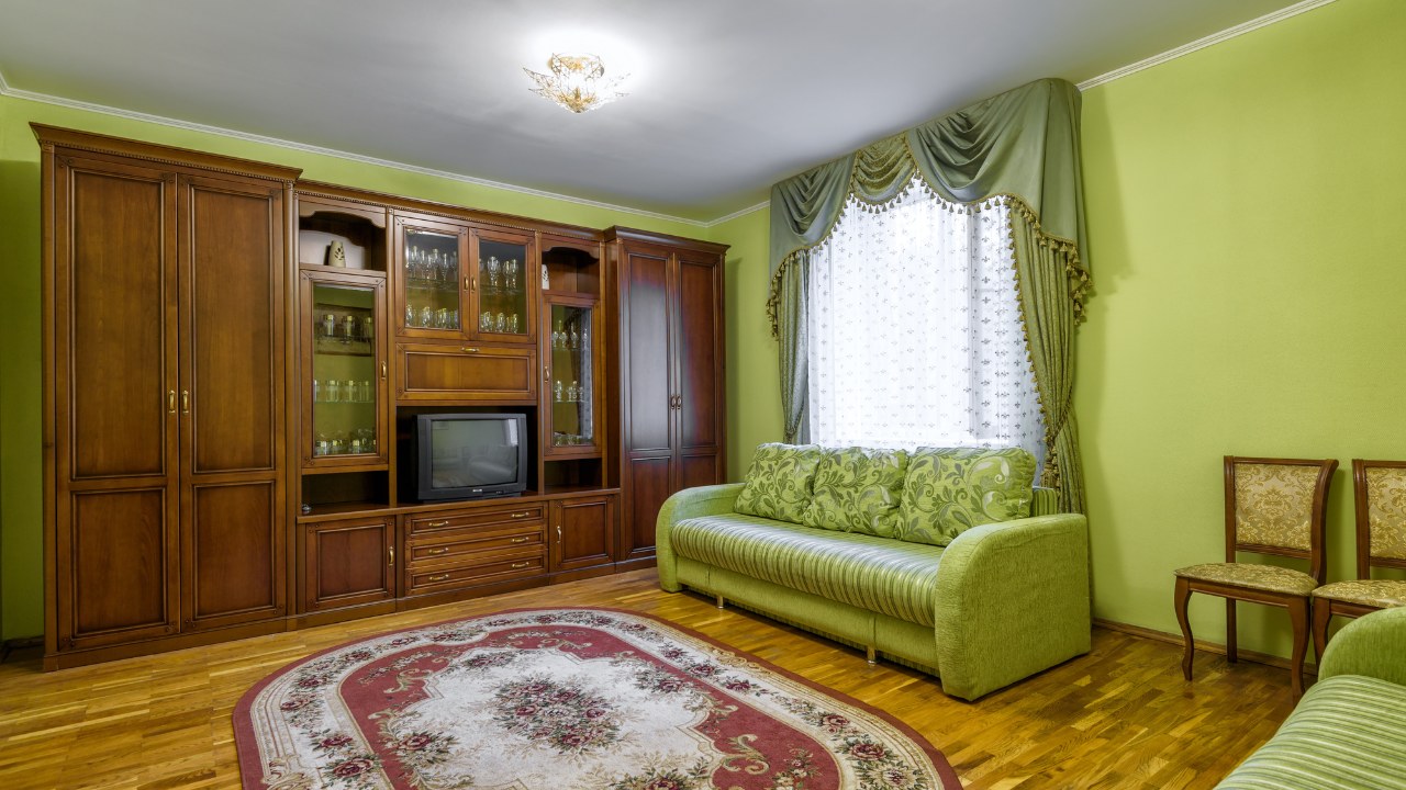 Panorama of vintage furniture, carpet and old TV inside living room. Contemporary apartment with retro decoration, 80s design. 