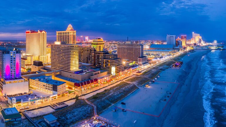 Aerial panorama of Atlantic city along the boardwalk at dusk.