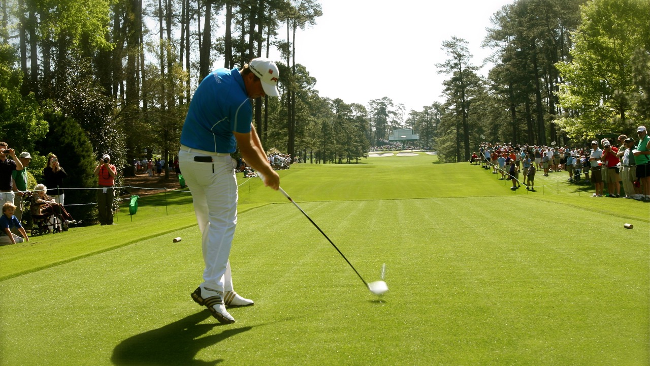 A golfer teeing off at the Masters in 2011.