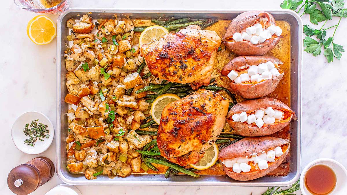 A Thanksgiving sheet pan recipe featuring roasted chicken, potatoes, and stuffing.