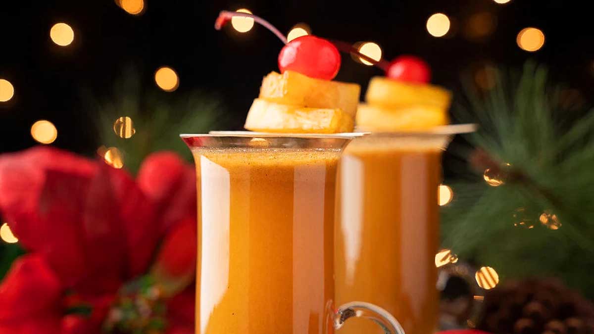 Fall cocktails featuring two glasses of mulled wine garnished with cherries on top.