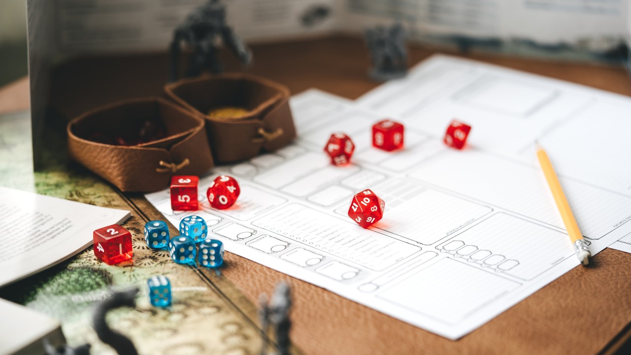 Role playing tabletop and board games hobby concept. D20 dice place on character sheets for create begin fantasy and adventure. Background with book and miniatures.