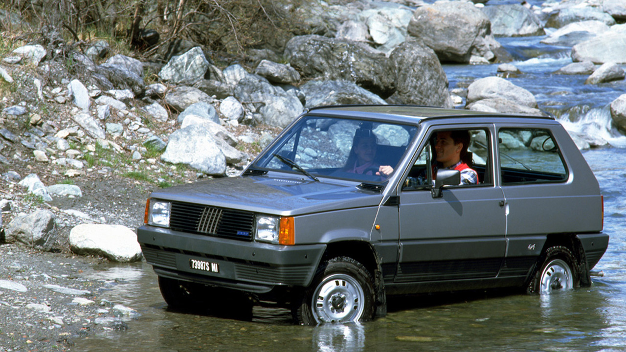 Fiat Panda 4x4, front 3/4 view, driving through water, gray exterior