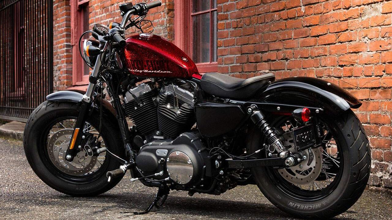 Red Harley-Davidson Forty-Eight parked in an alley.