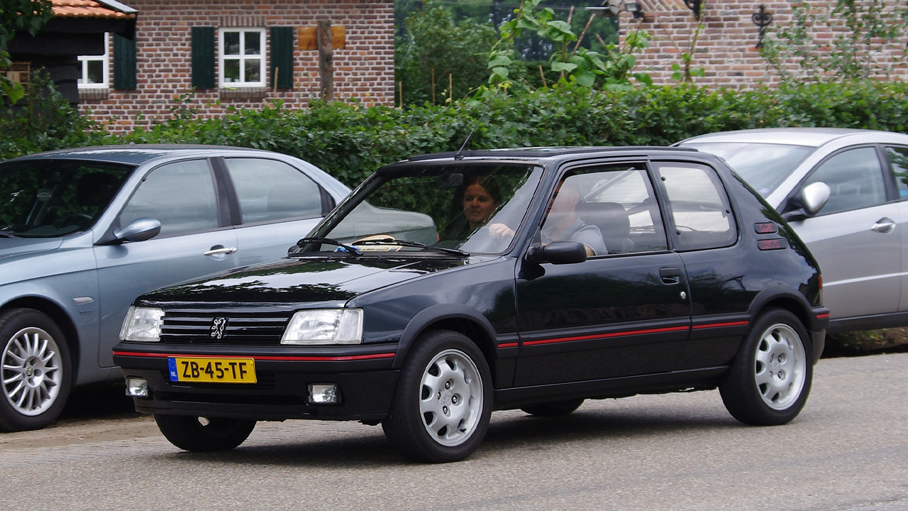 Peugeot 205 GTI, front 3/4 view, driving, black exterior
