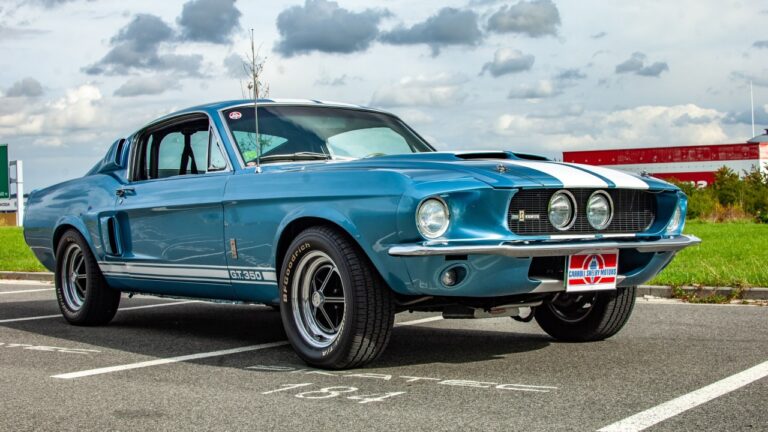 Low front-side view of a blue and white Ford Mustang Shelby GT 350 in parking lot.