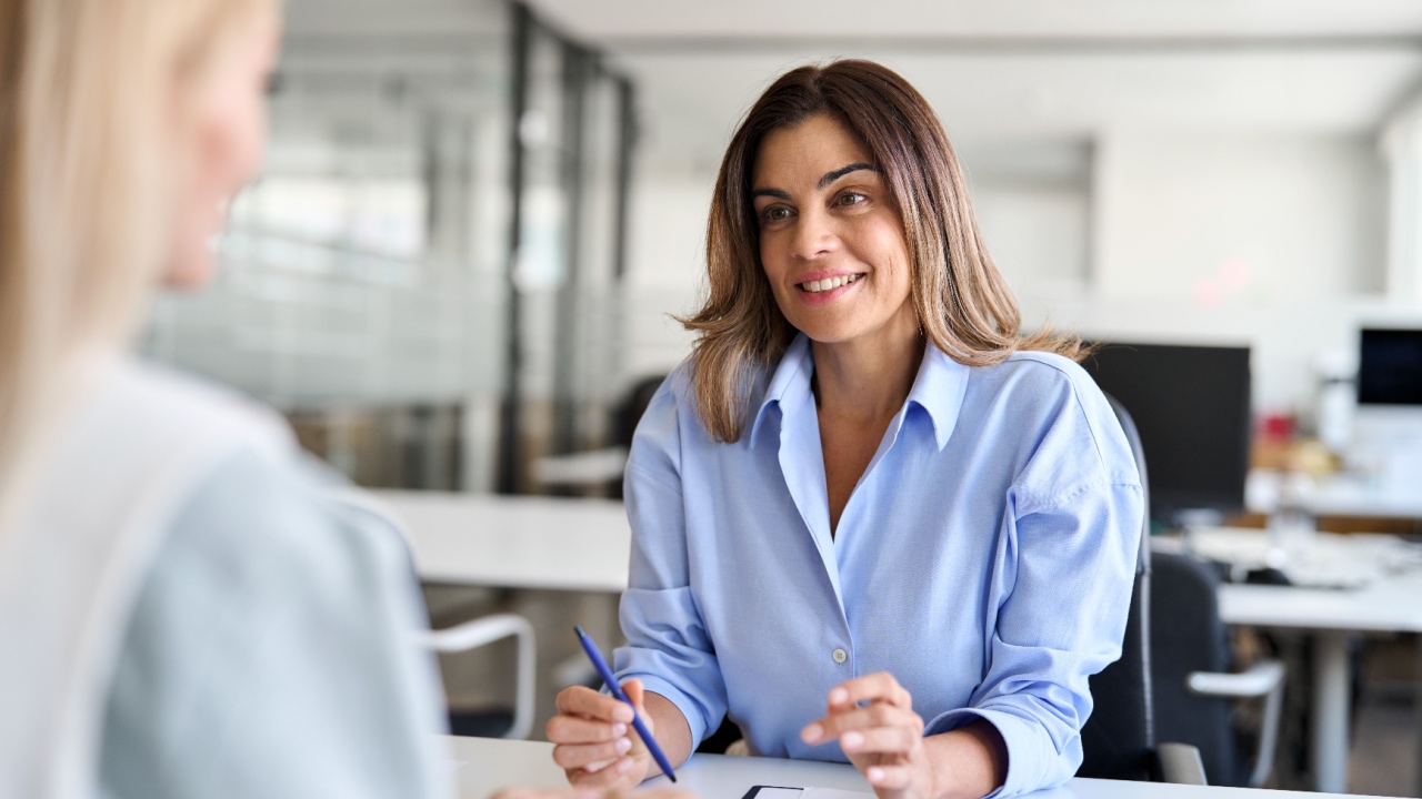 Woman talking with boss, interview, discussion